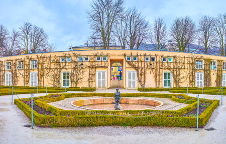 SALZBURG, AUSTRIA - MARCH 1, 2019: The small fountain with the sculpture surrounded with flower beds of Mirabell Gardens, on March 1 in Salzburgのeditorial素材