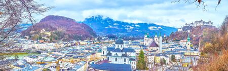 Watch Salzburg old town panorama from Monchsberg Hill - Hohensalzburg Fortress dominates the skyline and Salzach river divides city into two parts, Austriaの写真素材