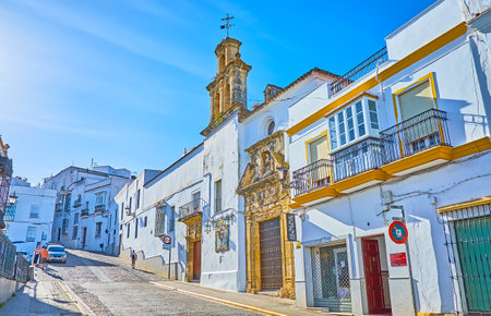 ARCOS, SPAIN - SEPTEMBER 23, 2019: The hilly Calle Corredera street with dense white houses and Hospital - San Juan de Dios church, sandwiched among the living buildings, on September 23 in Arcosのeditorial素材