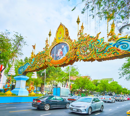 BANGKOK, THAILAND - MAY 13, 2019: The busy traffic in Ratchadamnoen avenue, decorated with ornamental arches and garlands due to the Coronation of Rama X, on May 13 in Bangkokのeditorial素材