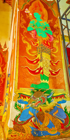 BANGKOK, THAILAND - MAY 13, 2019: The column in Wat Tri Thotsathep temple with scenic mural, depicting the deity, standing on the shoulders of Yaksha demon-king, on May 13 in Bangkokのeditorial素材