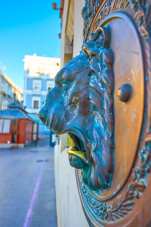 The post- box on the wall of MAin post office in Cadiz is decorated with bronze carved lion-head with open mouth, Spainのeditorial素材
