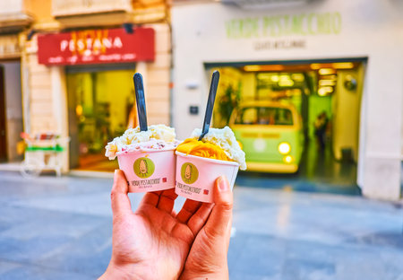 CADIZ, SPAIN - SEPTEMBER 23, 2019: Two cardboard cups with ice-cream in front of cafe in Calle Ancha, on September 23 in Cadizのeditorial素材