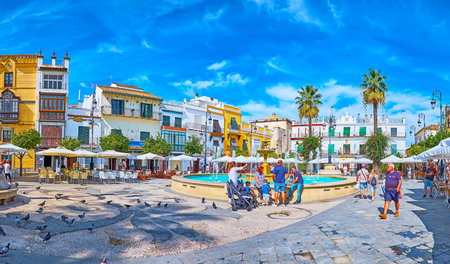 SANLUCAR, SPAIN - SEPTEMBER 22, 2019: Panorama of Plaza del Cabildo square with old fountain, cozy cafes and bars, historic edifices, on September 22 in Sanlucarのeditorial素材