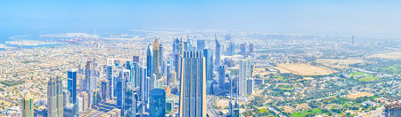 DUBAI, UAE - MARCH 3, 2020: The panorama of the Dubai skyline with sea shore on background and group of modern skyscrapers, built in business district, on March 3 in Dubaiのeditorial素材