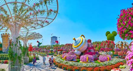 DUBAI, UAE - MARCH 5, 2020: Panorama of Miracle Garden grounds with scenic teapot installation, colorful flower beds and large sunshades, on March 5 in Dubaiのeditorial素材