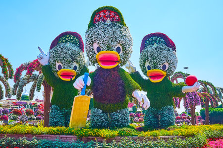 DUBAI, UAE - MARCH 5, 2020: The cartoon characters of Ducktales - Huey, Dewey and Louie Duck, covered with green plants and flowers in Miracle Garden, on March 5 in Dubaiのeditorial素材