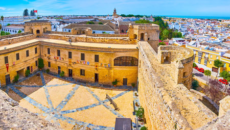 SANLUCAR, SPAIN - SEPTEMBER 22, 2019: Panorama from tower of Santiago Castle with its medieval court, roofs of old bodegas wineries, white housing and Atlantic Ocean coast, on September 22 in Sanlucarのeditorial素材