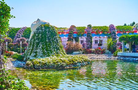 DUBAI, UAE - MARCH 5, 2020: The installation of the woman's head with floral hair, hanging to the pond in Miracle Garden, on March 5 in Dubaiのeditorial素材