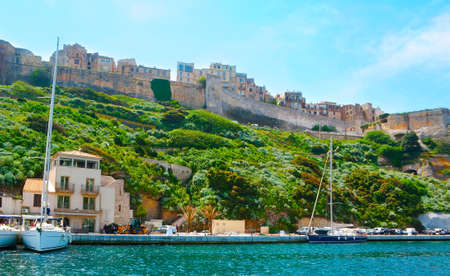 The medieval ramparts of Citadel and historic houses of old town from the harbor of Bonifacio, Corsica, Franceの写真素材