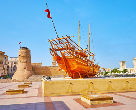 The traditional wooden dhow boat installation in front of the medieval Al Fahidi Fort in old town of Subai, UAEのeditorial素材