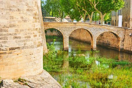 The small arched bridge across the moat of the Royal Castle of Tarascon, Franceのeditorial素材