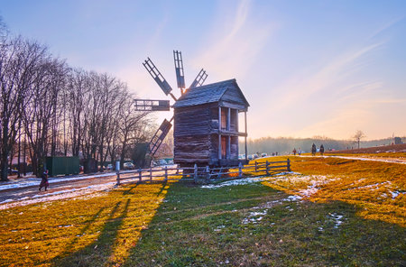 The evening sun is seen through the sails of the old timber windmill, Pyrohiv Skansen, Kyiv, Ukraineのeditorial素材