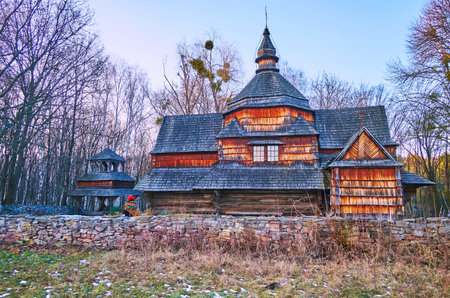 The timber Chuch of St Michael with a belfry and roof, made of wooden scales, Podillya Region architecture, Pyrohiv Skansen, Kyiv, Ukraineのeditorial素材