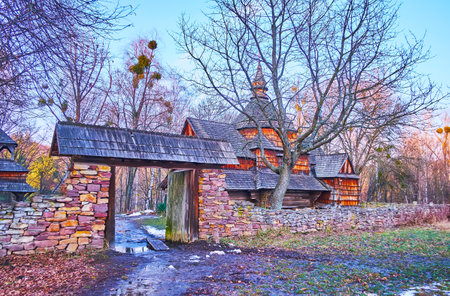 The historic St Michael Church is seen behind the stone gate, Podillya Region architecture, Pyrohiv Skansen, Kyiv, Ukraineのeditorial素材