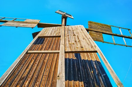 The close-up of historic wooden windmill with preserved sails, Pyrohiv Skansen, Kyiv, Ukraine