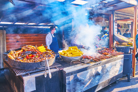 KYIV, UKRAINE  - MARCH 13, 2021: The holiday food fair with grilled pork, sausages, corn, veggies and mushrooms on the celebration of Maslyana (Maslenitsa, Kolodiy) in Pyrohiv Skansen, on March 13, 2021のeditorial素材
