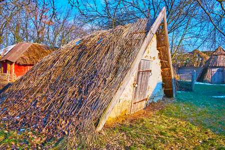 The leaning clay building of the root cellar with straw roof, Pyrohiv Skansen, Kyiv, Ukraineのeditorial素材
