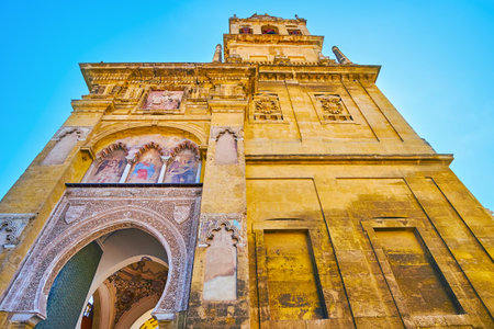 The Door of Forgiveness (Puerta del Perdon) is located under the bell tower and decorated with horseshoe arch, relief patterns, frescoes and alfiz (blind arcade) of polylobed arches, Mezquita, Cordoba, Spainのeditorial素材