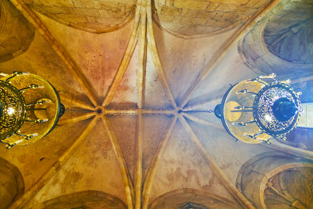 CORDOBA, SPAIN - SEPTEMBER 30, 2019: The sandstone rib-vaulted ceiling of San Bartolome chapel with vintage chandeliers, on September 30 in Cordobaのeditorial素材