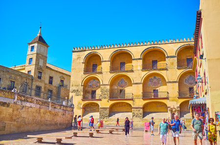 CORDOBA, SPAIN - SEPTEMBER 30, 2019: Walk Triumph Square and enjoy the view of medieval wall of Mezquita, decorated with niches and coats of arms, on September 30 in Cordobaのeditorial素材