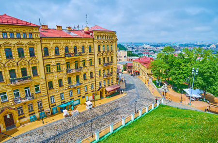 Historic Andrew's Descent (Andriivskiy Uzviz, Andreevskiy Spusk) street with ornate old mansions, houses, cafes, restaurants, art galleries and souvenir shops, Podil (Podol) district, Kyiv, Ukraineのeditorial素材