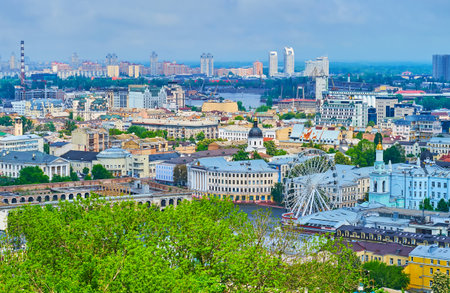 The view of historic buildings and ferris wheel in Podil neighborhood and the modern high-rises of Obolon neighborhood in background, Kyiv, Ukraineのeditorial素材