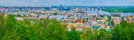 Panorama of Podil neighborhood in lush greenery, Dnieper River, bridges, ferris wheel and Obolon neighborhood in background, Kyiv, Ukraineのeditorial素材
