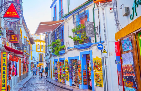 CORDOBA, SPAIN - SEP 30, 2019: The colorful souvenir stores and art galleries of the Juderia tourist market, Calle Romero street, on Sep 30 in Cordobaのeditorial素材