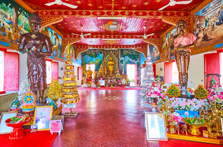 LAMHPUN, THAILAND - MAY 8, 2019: The bright red interior of Viharn Phra Chao Lawo of Wat Phra That Hariphunchai Temple, on May 8 in Lamphunのeditorial素材