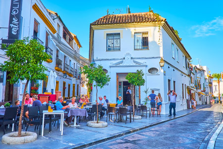 CORDOBA, SPAIN - SEPTEMBER 30, 2019: The cozy outdoor restaurant among the scenic white houses of Cardenal Gonzalez street, on September 30 in Cordobaのeditorial素材