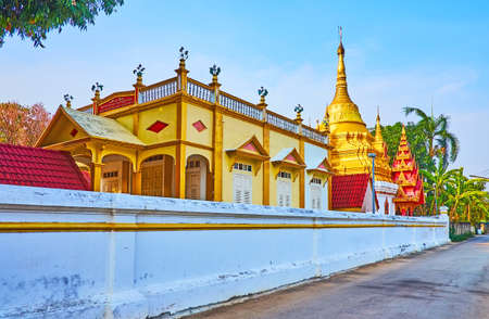 The buildings of Wat Tha Ma-O Temple with scenic decorations and the golden Chedi, Lampang, Thailandの写真素材