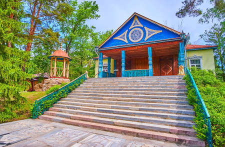 The facade of traditional wooden house with painted pillars and carved details, Pereiaslav Scansen, Ukraineの写真素材