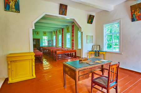 PEREIASLAV, UKRAINE - MAY 22, 2021: The vintage classroom of old village school with authentic furniture - blackboard, teacher's table, pupils' descs, cabinet, abacus, Pereiaslav Scansen, on May 22 in Pereiaslavのeditorial素材