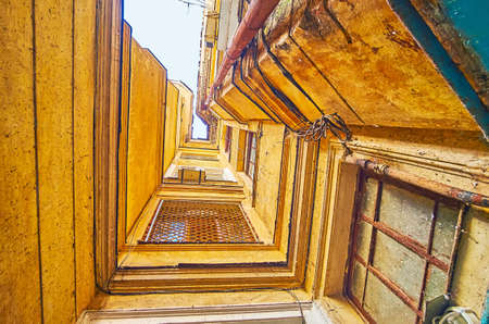 The upward view of the shabby corner of multistorey house  with windows and crumbling paint, Odessa, Ukraineの写真素材