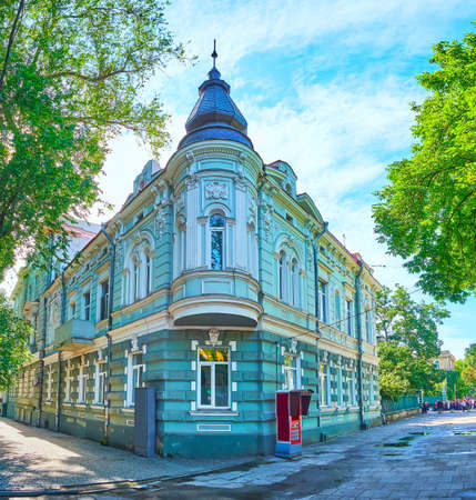 The corner facade of historic building of the city hospital (former tenement house of Greek Orthodox Church), decorated with oriel window and moulding, Troitskaya street, Odessa, Ukraineの写真素材