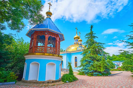 The scenic green park with a church and wooden belfry of Archangel Michael Nunnery, Odessa, Ukraineの写真素材