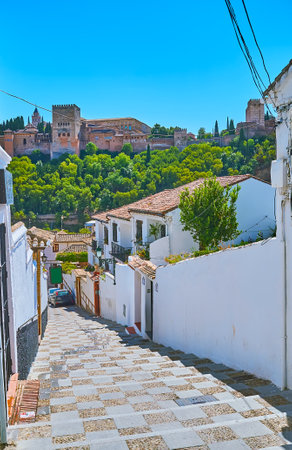 Walk the long stairway between historic white houses of Albaicin and watch magnificent Alhambra fortress, Granada, Spainのeditorial素材