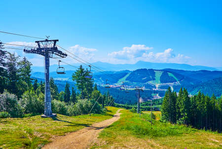 The riding cable car and stunning Gorgany Range landscape from the mountain top, Bukovel, Carpathians, Ukraineの写真素材