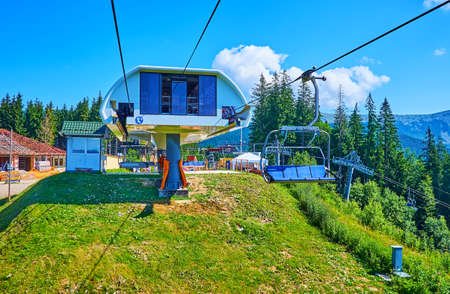 The modern upper chairlift station, located amid the green spruce forest on the slope of  Mount Babyn Pohar of Gorgany Mountain Range, Bukovel, Carpathians, Ukraineの写真素材