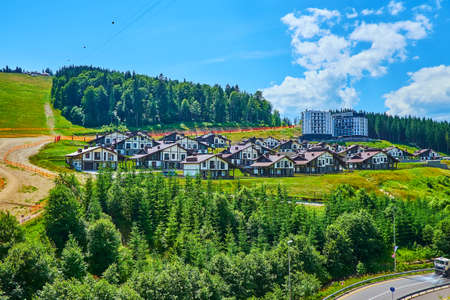 The modern luxury neighborhood on the slope of Bukovel mount with Alpine style half-timbered cottages, Carpathians, Ukraineの写真素材