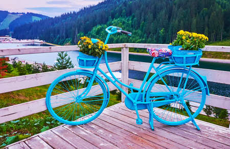 The scenic blue bike installation on the embankment of Molodist Lake, Bukovel, Carpathians, Ukraineの写真素材