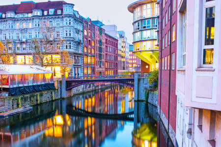 The scenic neighborhood in Altstadt with Herrengrabenfleet canal with beautiful high buildings and bridges, Hamburg, Germanyの写真素材