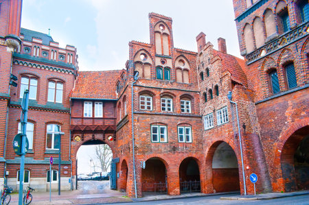 Astonishing medieval brick Burgtor Gates of Lubeck with arched passes is one of the best examples of German Gothic style, Germanyの写真素材