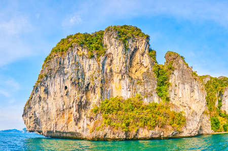 The pleasant yacht trip around famous Chicken Island (Koh Kai) with rocky coast and lush greenery on the slopes, Ao Nang, Thailandの写真素材