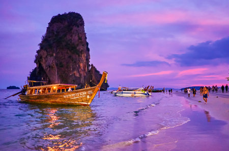 AO NANG, THAILAND - APRIL 26, 2019: The pleasant night walk along Phra nang Beach, one of the most spectacular part of Railay Beach with huge rock in the sea, on April 26 in Ao Nangのeditorial素材