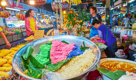 CHIANG MAI, THAILAND - MAY 4, 2019: The stall of farmers Gate Market sells ingredients for mango sticky rice Thai dessert - colored rice, fresh mangos and coconut milk, on May 4 in Chiang Maiのeditorial素材