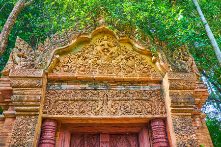 CHIANG MAI, THAILAND - MAY 4, 2019: Detail of the ornate terracotta gate of Baan Phor Liang Meun Terracotta Arts Hotel with sculptures and fine floral patterns, on May 4 in Chiang Maiのeditorial素材