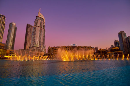 DUBAI, UAE - MARCH 3, 2020: The great illuminated Fountain Show and purple sky of the twilight sky, on March 3 in Dubaiのeditorial素材