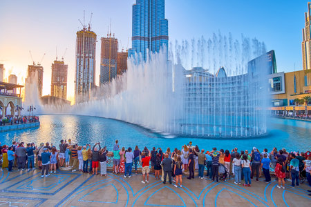 DUBAI, UAE - MARCH 3, 2020: Very popular everyday evening Fountain Show, performing in the heart of Downtown district on Burj Lake, on March 3 in Dubaiのeditorial素材